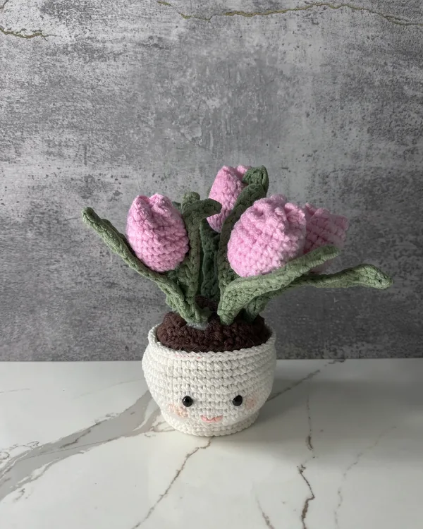 Crochet pink tulips in a smiling pot
